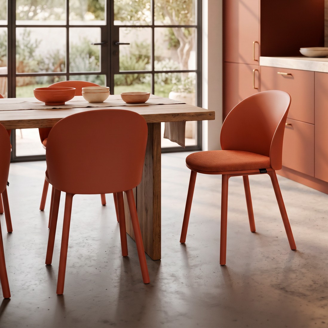 Stella orange polypropylene chair with cushioned seat